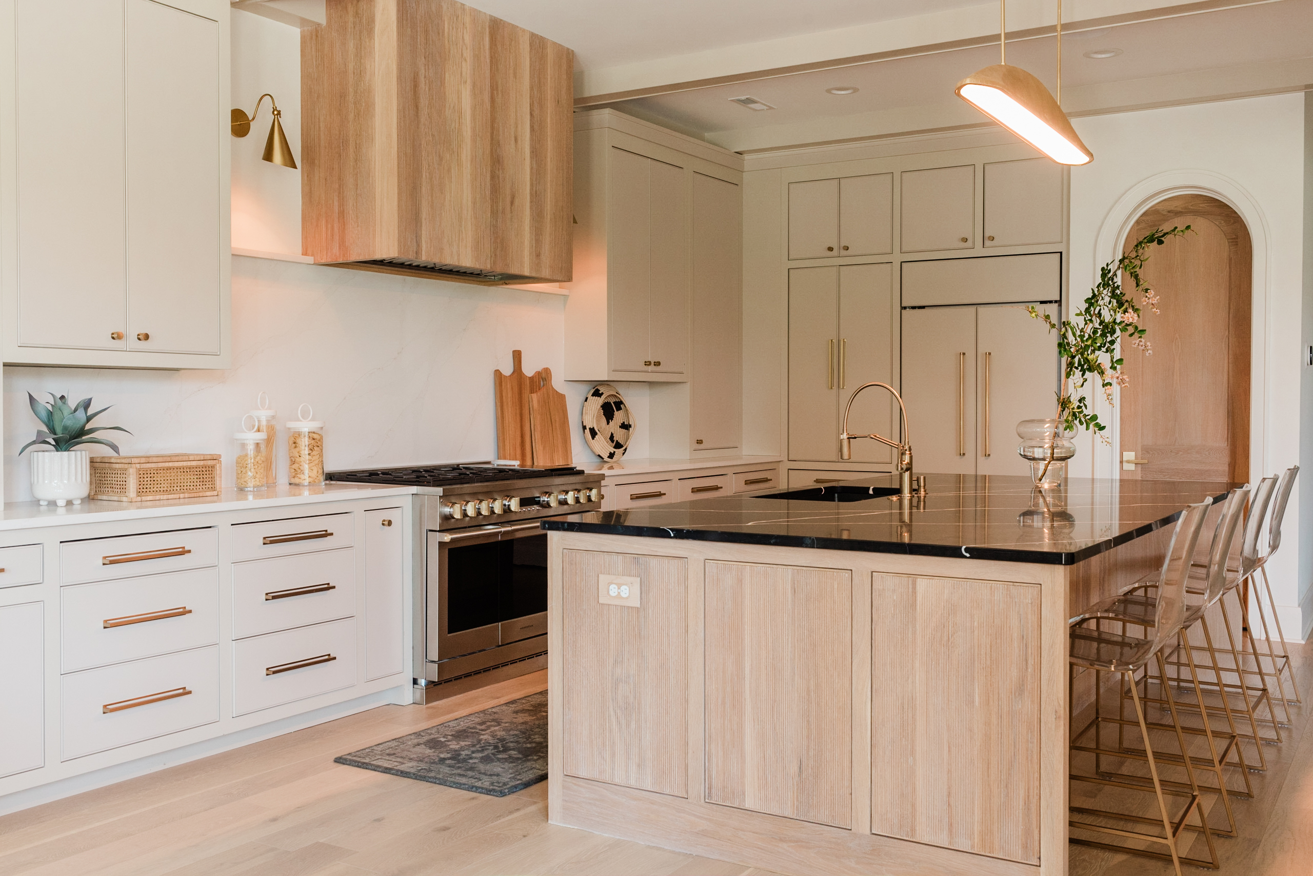 With the goal of achieving a modern organic design style, the designers behind this custom kitchen opted for neutral tones, heavy texture, and natural light. Photo: James and Company Photography