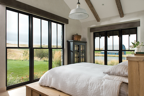 Kolbe Windows &amp; Doors’ Sterling double hungs with divided lites offer floor-to-ceiling pastoral views.