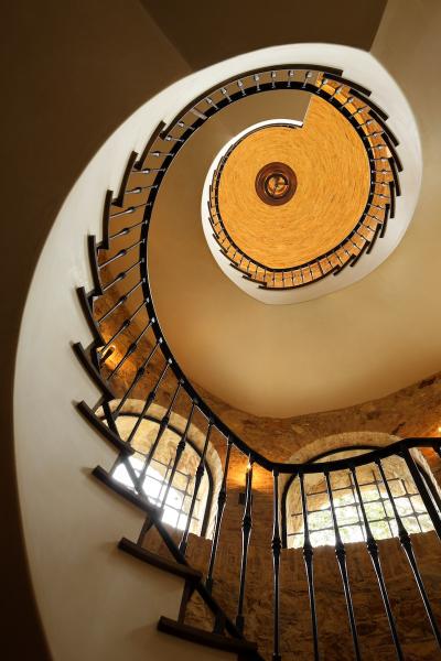 Italian-style stairway design by Richard Landry rising in a stair tower