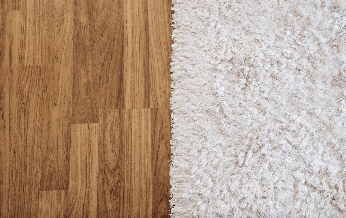 Laminated timber flooring next to white carpet